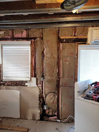 Studs exposed and dried in a bathroom