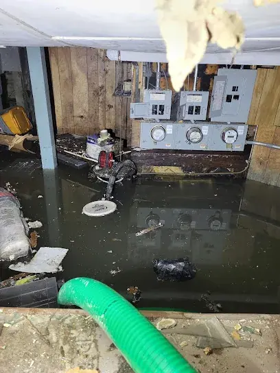 Sewage cleanup crew in protective gear