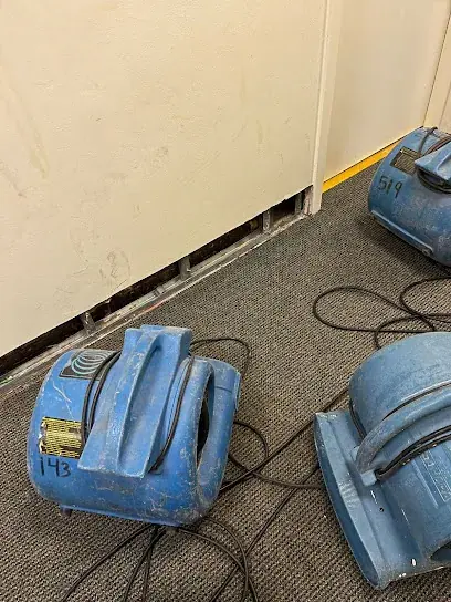 Air movers and dehumidifiers drying a structure